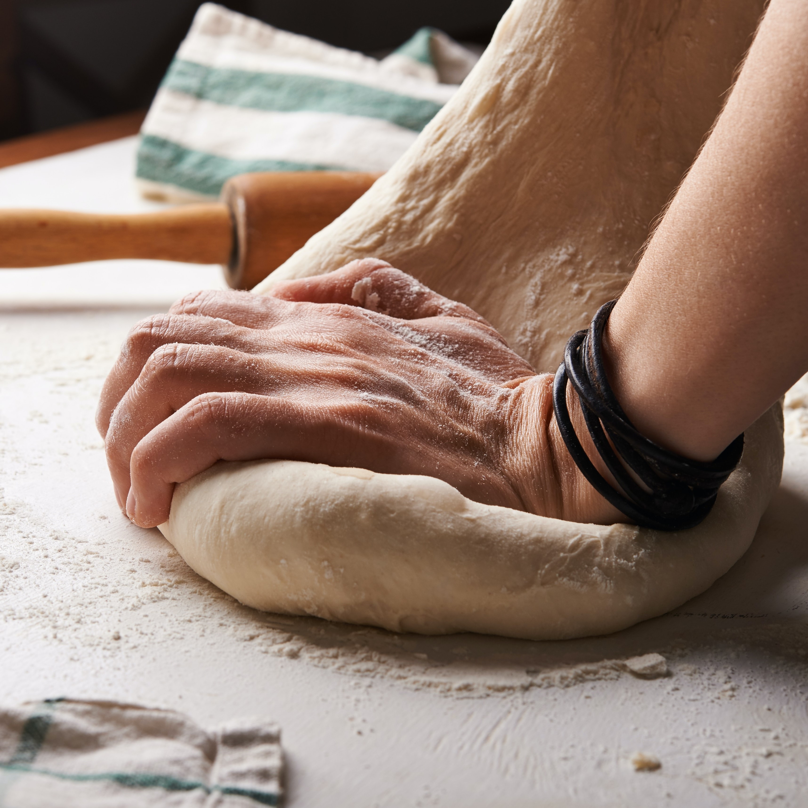 male hands kneading dough