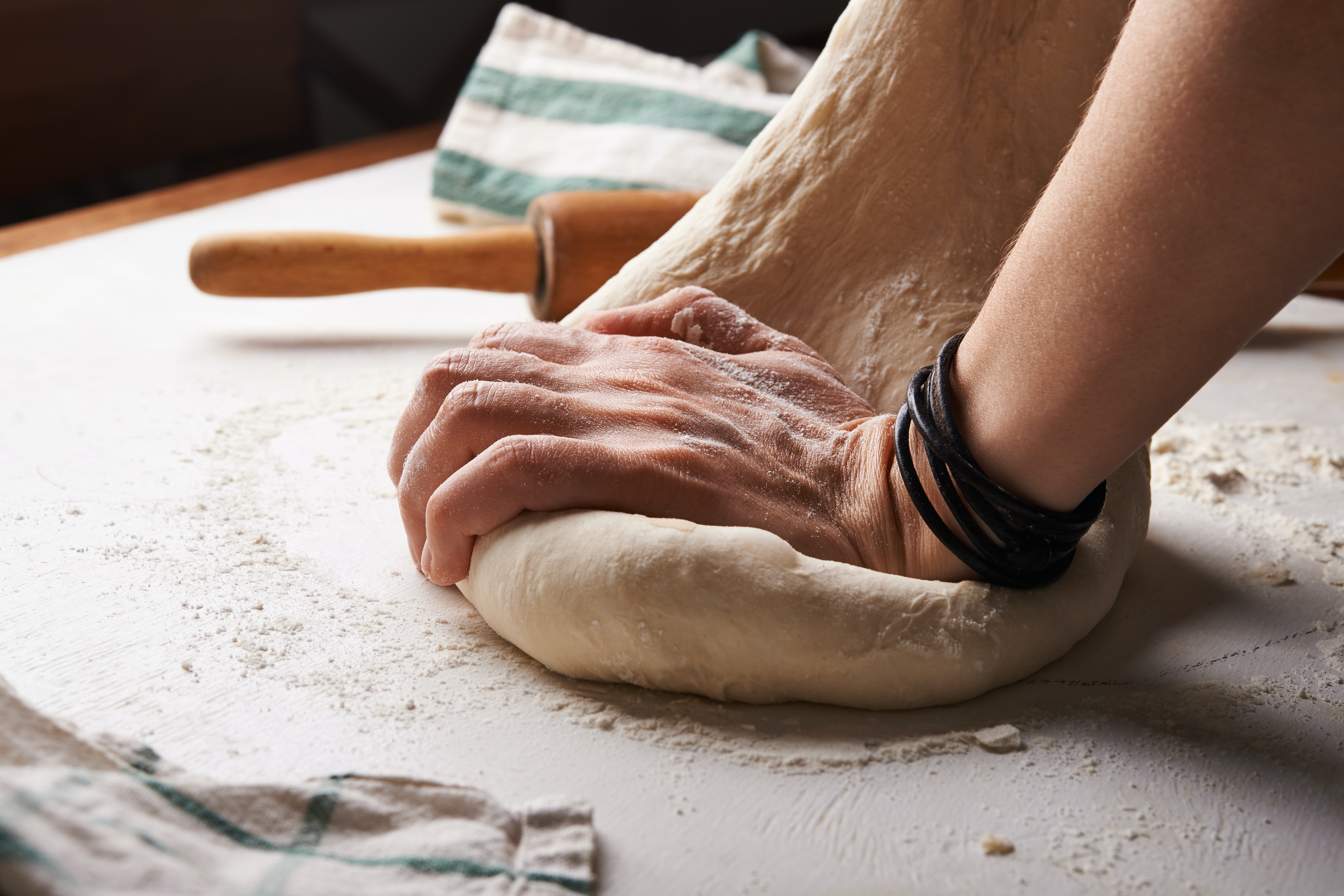 male hands kneading dough