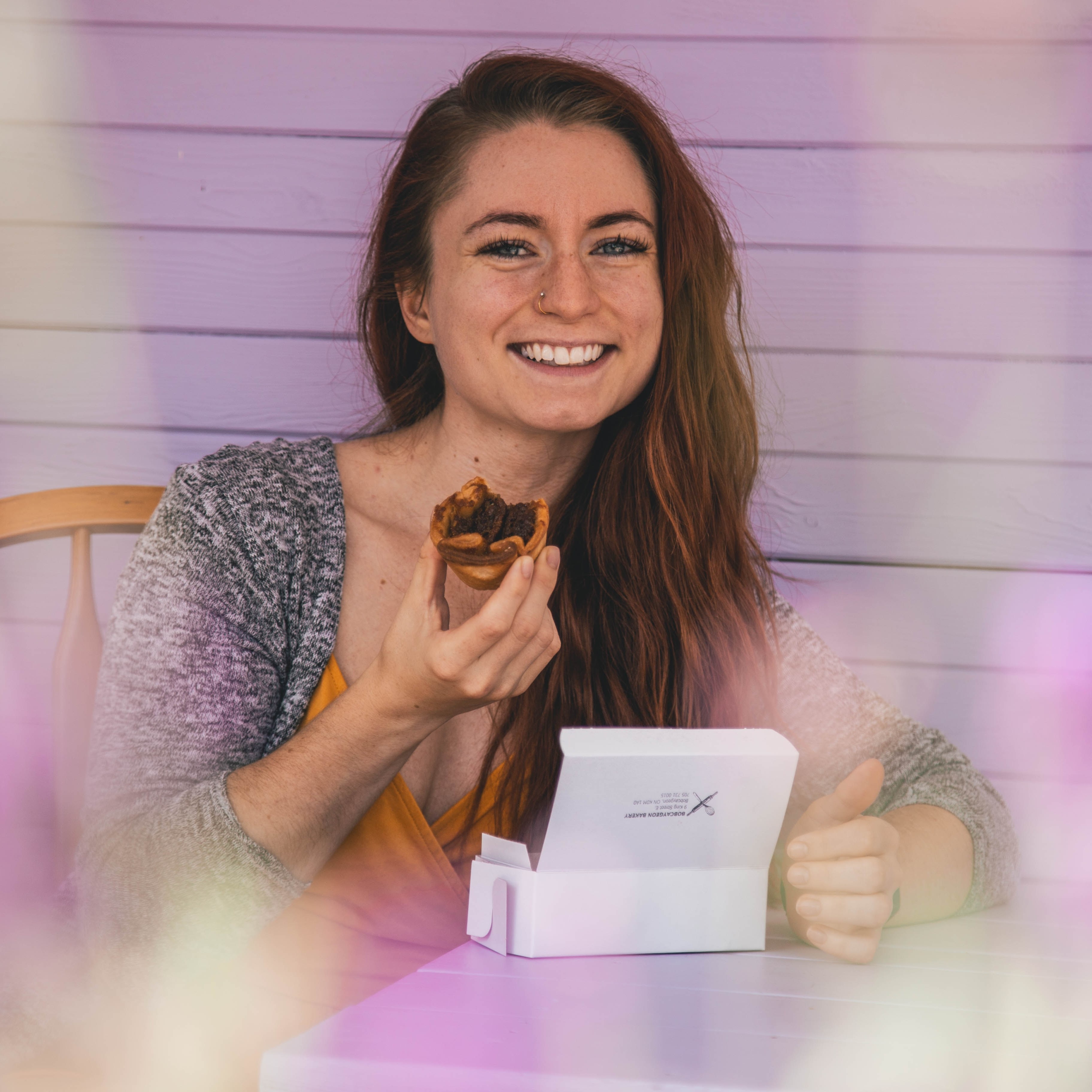 female holding a pastry